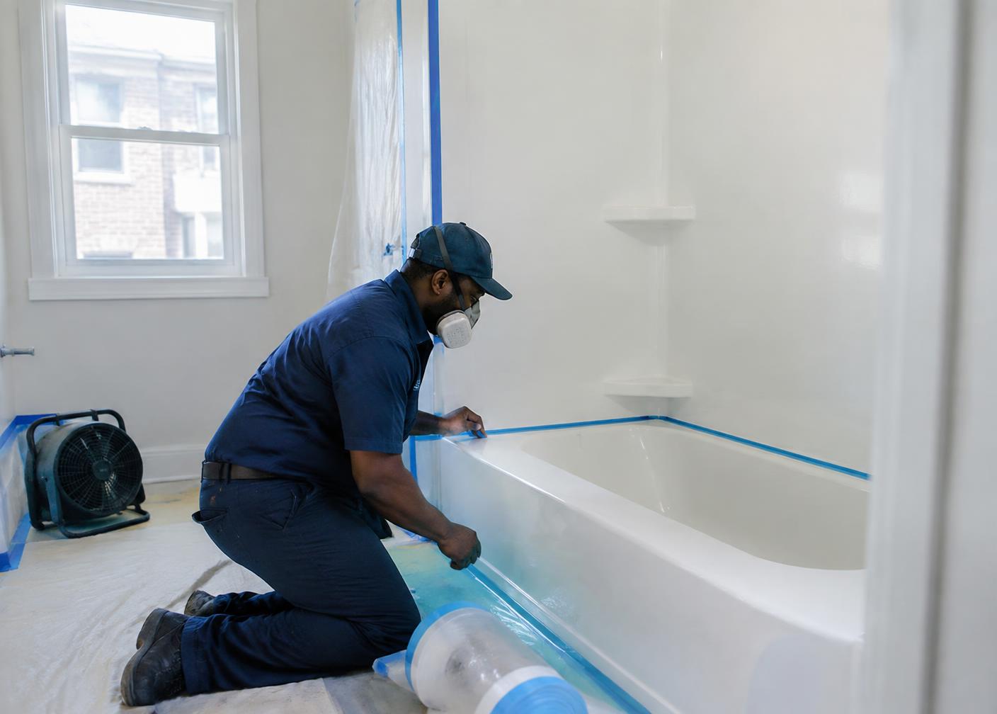 Technician preparing a bathtub with containment and ventilation